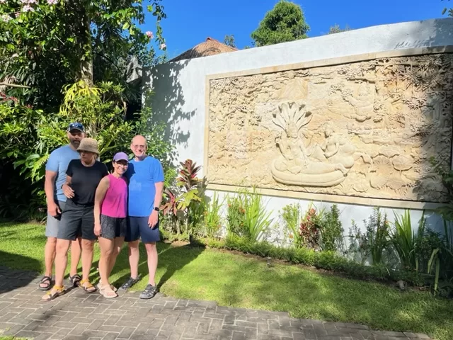 guests pose near carving